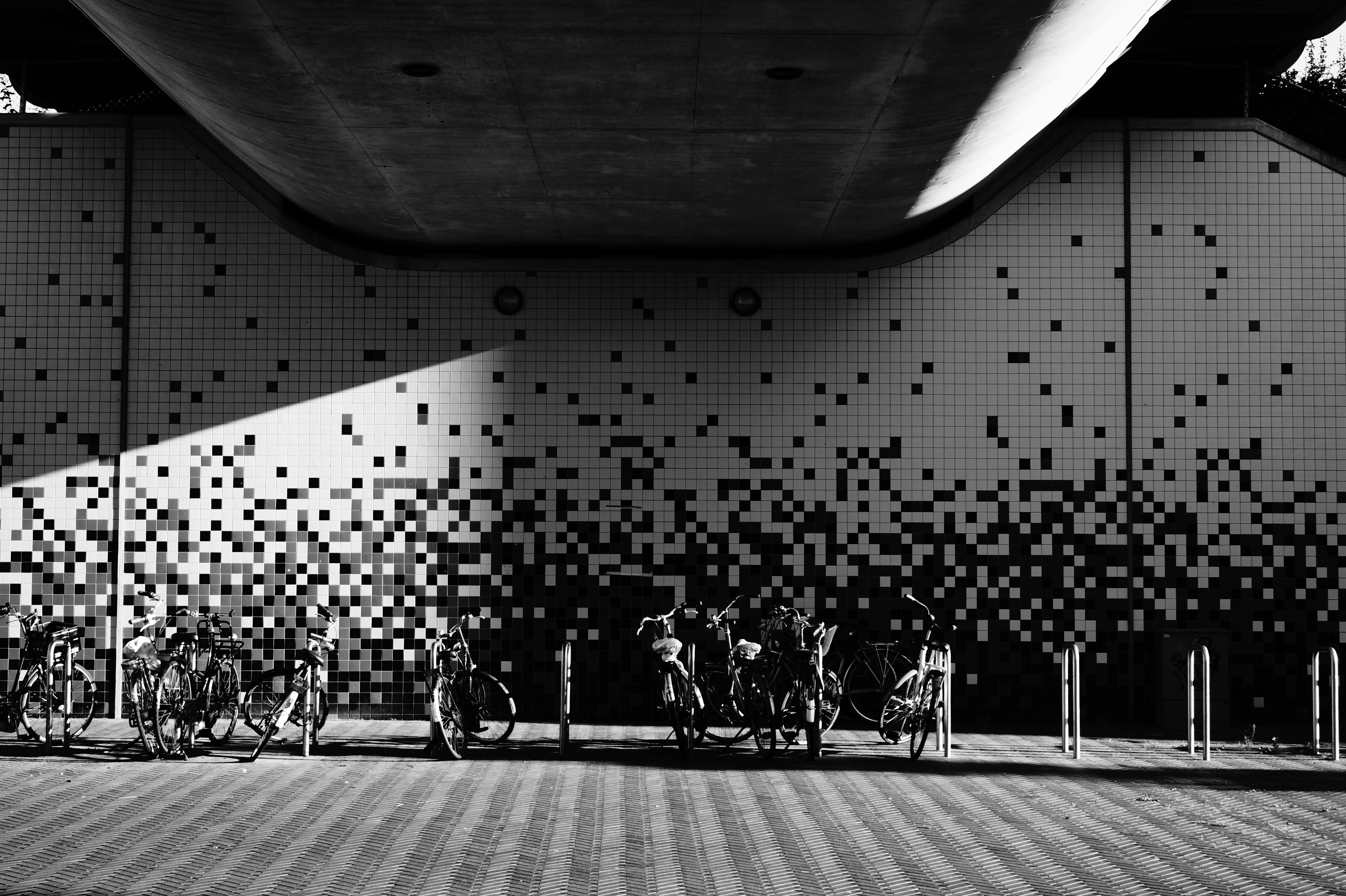 bike racks with black and white tiled walls