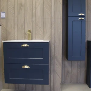 A bathroom unit including a sink with drawers below and a cupboard above and to the right. the walls have a wood effect style.