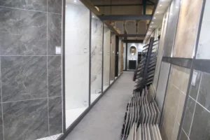 A showroom with a selection of tiles on the right hand side and showers on the left hand side of the image.
